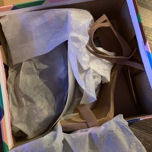 Mauve colored heel with gold heel and zipper on heel.